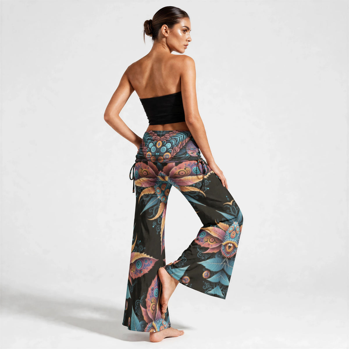 Back view of the printed wide leg pants showing symmetrical leaf and ring motifs flowing to the hem.