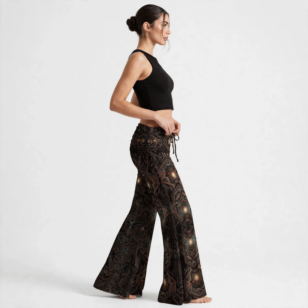 (Side) Side view of floor-length wide leg pants in a bronze and black geometric print, showing the flowing flare silhouette.