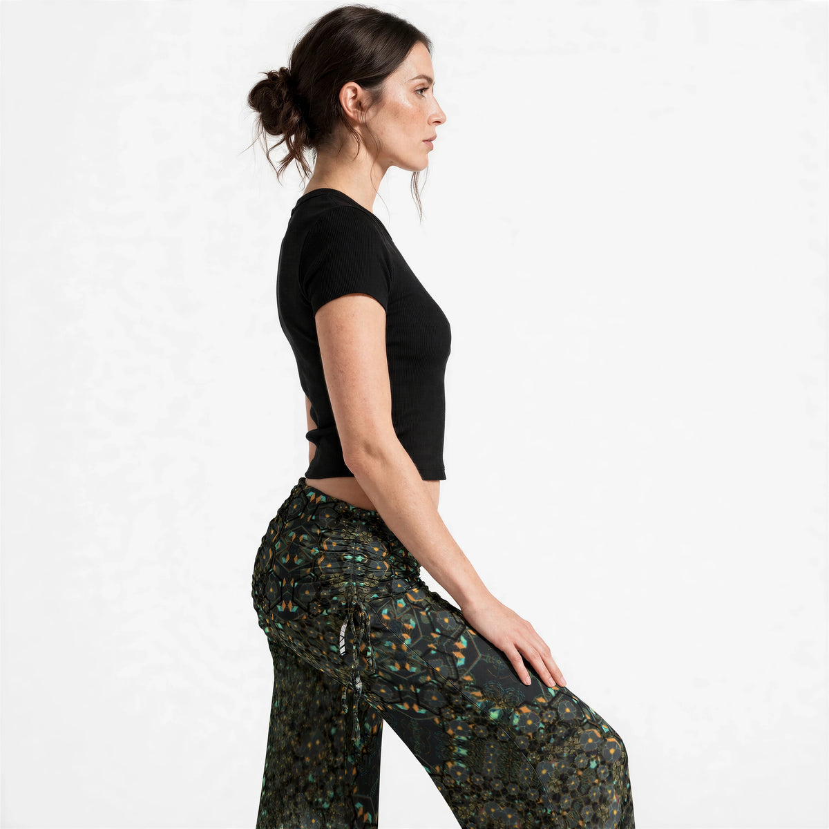 Side view of the mandala print wide leg pants, showing the gathered waistband and flowing floor-length drape.