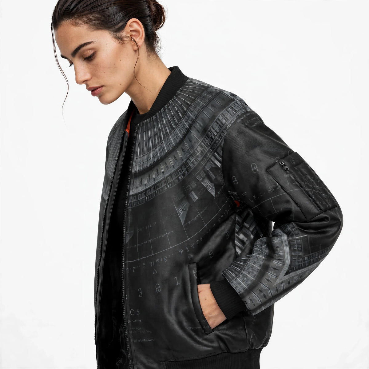 Three-quarter view of the black bomber jacket showing ribbed collar, front zip, side pockets and grey print wrapping the sleeves.