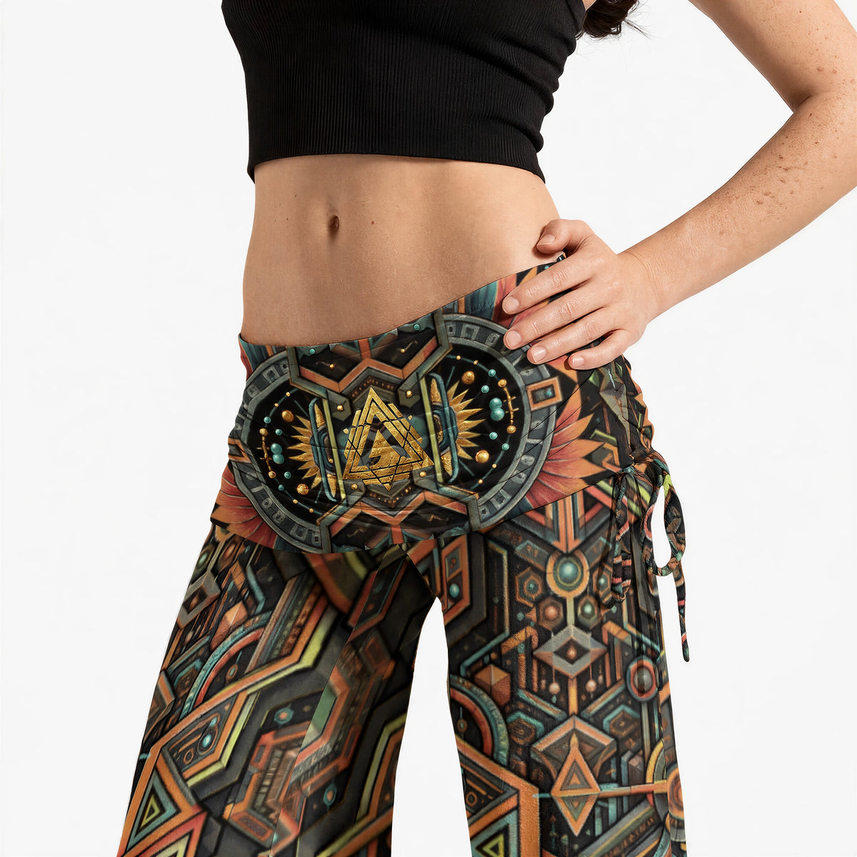 Close-up of the waistband emblem, layered triangle motif in gold tones, feathered sun-ray shapes and hip drawstring detail.