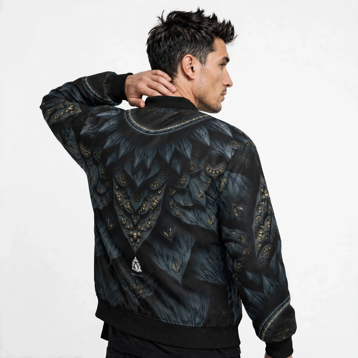 Back of the bomber jacket showing mirrored petal artwork across the shoulders and a small white triangular Anunaki logo on the lower back.